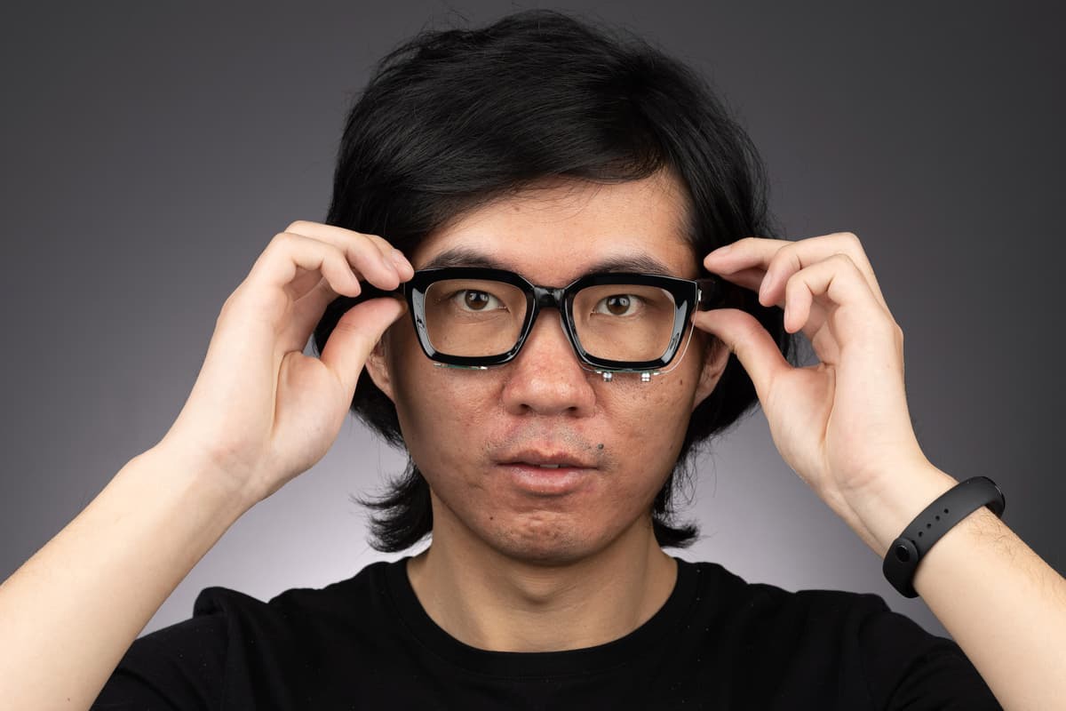 The EchoSpeech glasses (modeled here by lead scientist Ruidong Zhang) could be utilized to control devices, or even to help the voiceless communicate
